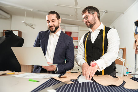 Joyous couturiers working on new menswear collection
