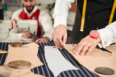 Two professionals working together in clothing atelierの写真素材