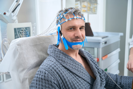 Man undergoes an EEG examination - electroencephalography in medical clinic