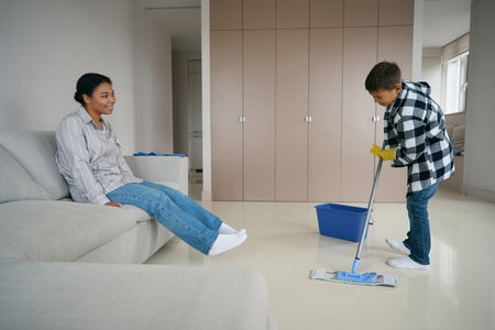 Hardworking boy washes in the living roomの写真素材