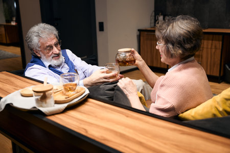 Old lady and man drinking tea and resting together