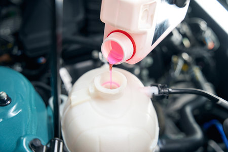 Close up photo of mechanic changing antifreeze fluidの写真素材