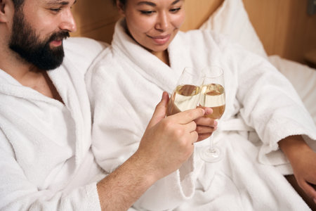 Man and his female companion celebrating anniversary in luxury suiteの写真素材