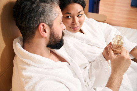 Woman and her companion celebrating anniversary in hotel roomの写真素材