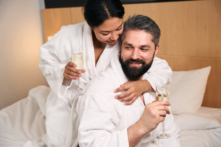 Young happy couple drinking to their anniversaryの写真素材