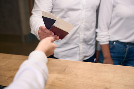 Male and female checking into hotel on arrivalの写真素材