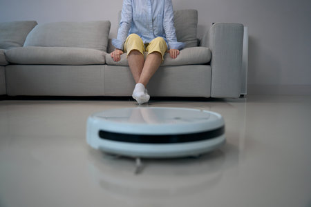 Lonely elderly lady sits on soft sofa inliving roomの写真素材
