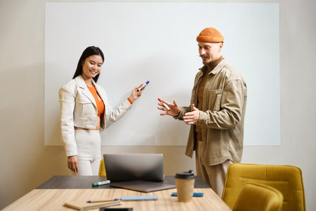 Smiling company employees giving online presentation in meeting roomの写真素材