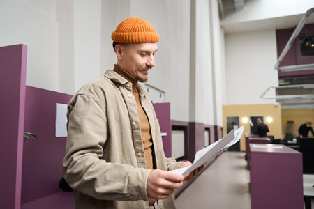 Corporate worker dealing with business documentation in open-place office