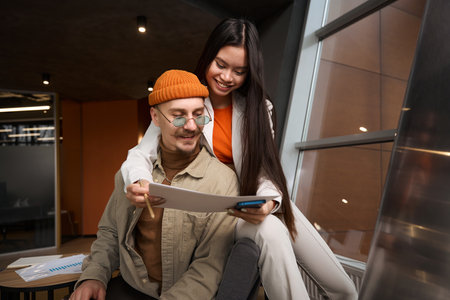 Young couple of office workers dealing with business documentationの写真素材