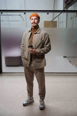 Modern company employee posing for camera during coffee breakの写真素材