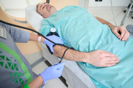 Doctor measures the patient blood pressure with a tonometer, CT diagnosticsの写真素材