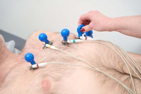 Doctor with male patient at medic electro cardiogramm test in hospitalの写真素材