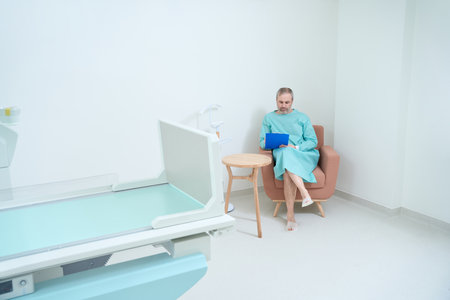 Male patient filling out a medical questionnaire in clinicの写真素材