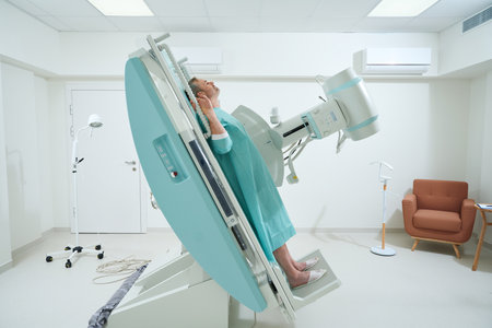 Adult man taking radiograph an X-Ray machine to scan for injuryの写真素材