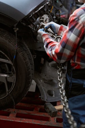 Man fastens a carabiner with a chain to car bodyの写真素材
