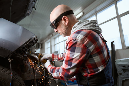 Handyman in goggles uses a pneumatic cutter