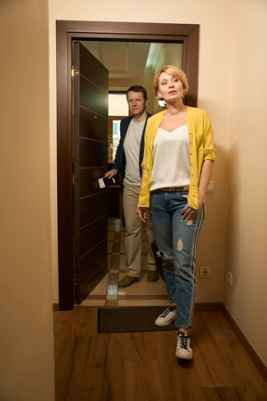 Traveling man and woman enter the room of hotel roomの写真素材