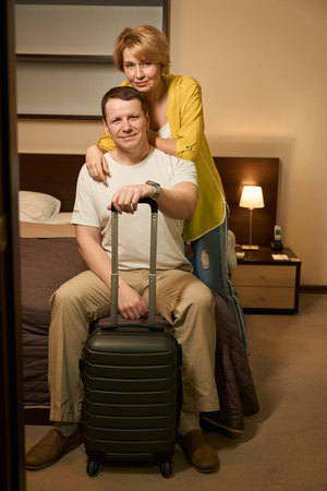 Traveling married couple checked into a modern comfortable hotelの写真素材
