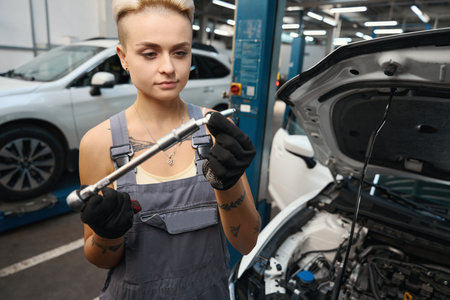 Blond woman repairing auto in detailing serviceの写真素材