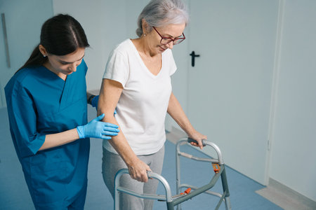Caring nurse accompanies an elderly patient in clinicの写真素材