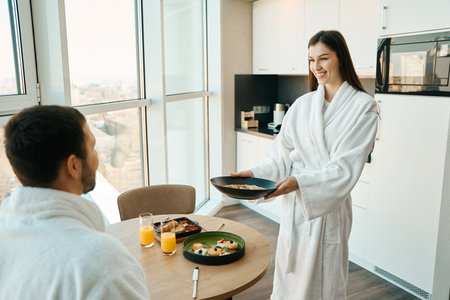 Female treats her beloved husband with a traditional breakfastの写真素材