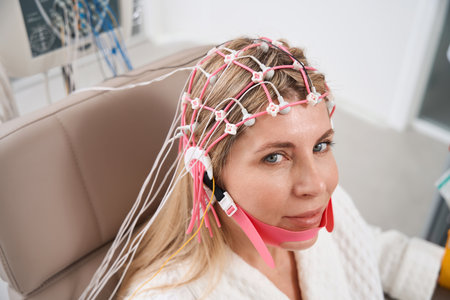 Beautiful woman in a cap with electrodes on electroencephalogram procedureの写真素材
