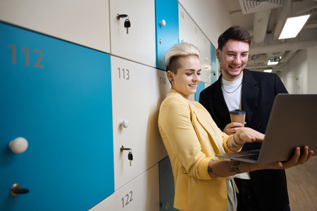 Designers working on laptop at luggage storageの写真素材