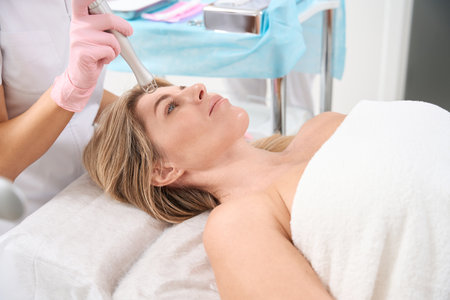 Beautiful woman on laser skin resurfacing procedure
