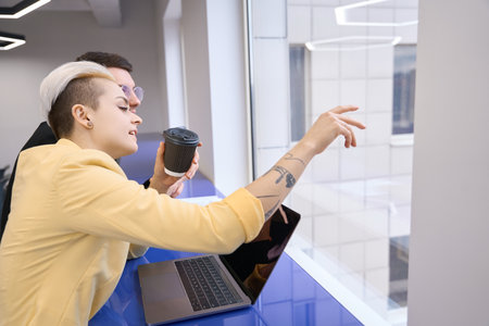 Woman showing to man her project at window