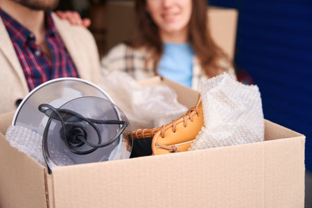 Close-up of cardboard box with things for moving into warehouse