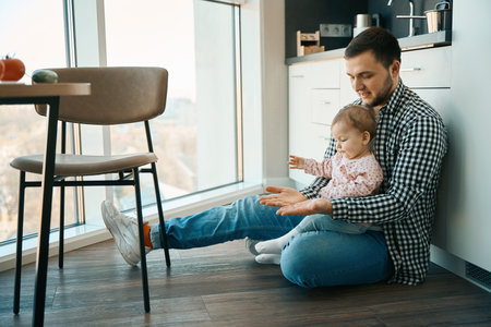 Loving young father plays patties with a little daughterの写真素材