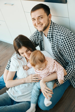 Smiling man holding his girls in his armsの写真素材