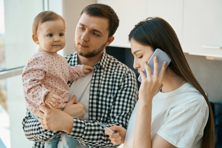 Caring mother holds a thermometer in her handsの写真素材