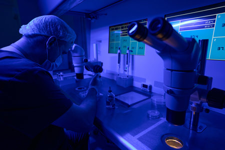 Technician working on in vitro fertilization of egg in special laboratoryの写真素材