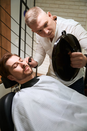 Modern young man at a consultation in a barbershopの写真素材