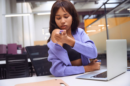Attractive female sitting in open space office