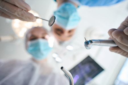 Surgeon dentist with assistant at the workplace in operating roomの写真素材