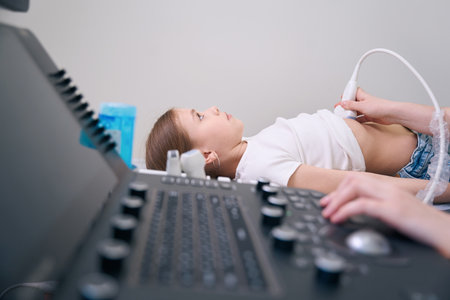 Little girl lies on a medical couch in ultrasound roomの写真素材