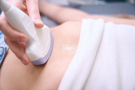 Diagnostician uses modern equipment for ultrasound of the internal organsの写真素材