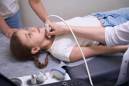 Young patient in a clinic for ultrasound of thyroid gland
