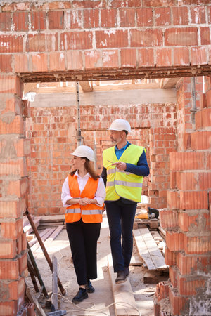 Couple of customers walking and considering building of their future houseの写真素材