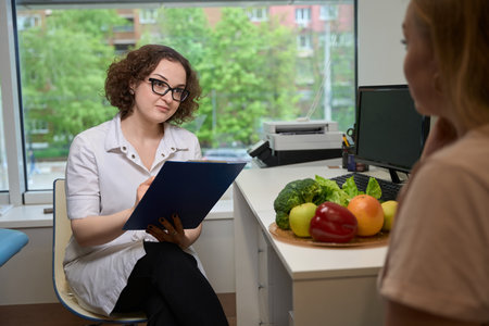 Woman nutritionist advises a client in a fitness clinicの写真素材