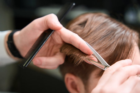 Photo of barber using scissors and comb indoorsの写真素材
