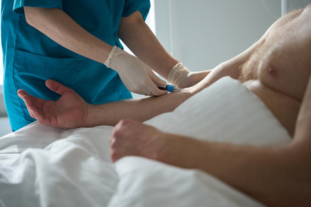 Nurse hands taking blood analysis from patients vein at clinicの写真素材