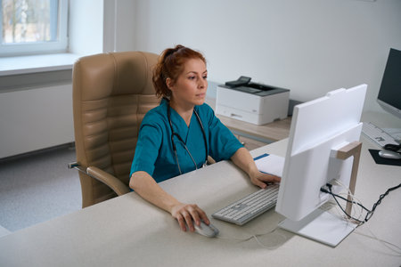 Female doctor working on the computer in office at the clinic