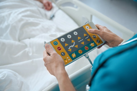 Doctors hands pressing buttons on supervisor control panel in wardの写真素材