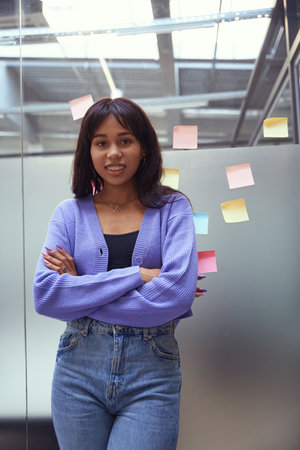 Attractive female posing at camera in modern officeの写真素材