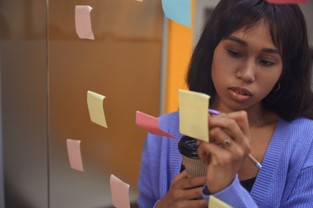 Young female making notes in modern room