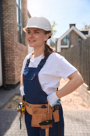 Woman building constructor inspecting building with professional viewの写真素材
